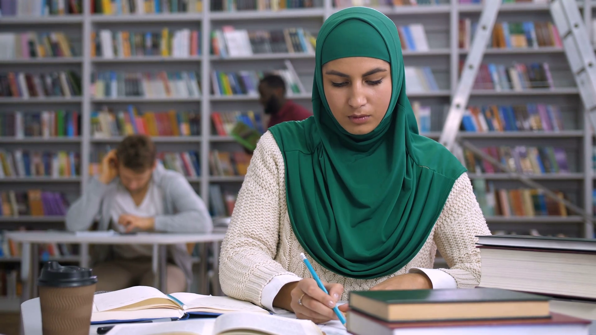Lovely muslim female architect student in hijab working with sketch and