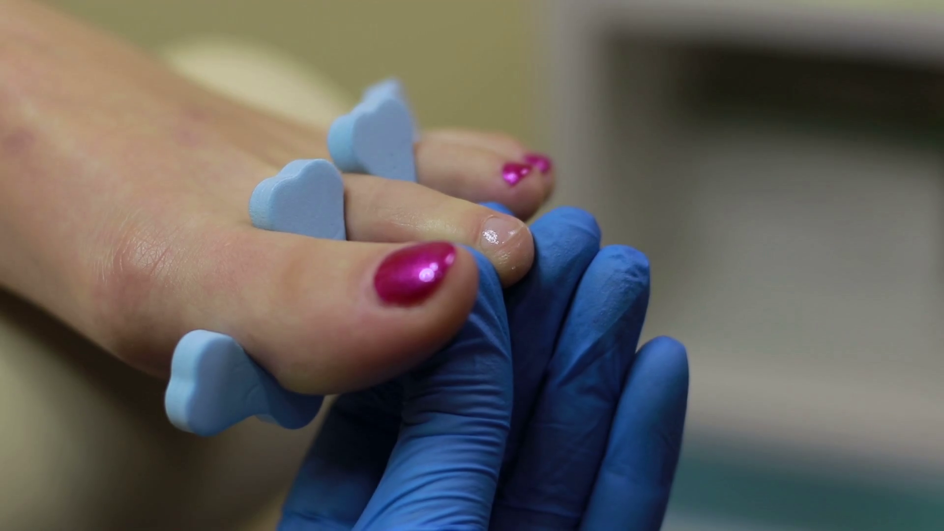 Pedicurist applying nail polish to toenails Stock Video Footage 0018
