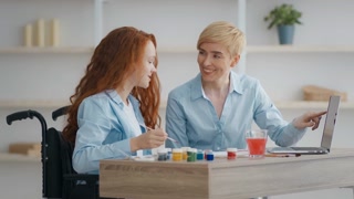 Mother and daughter exercising and learning together at home