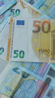 Vertical Countless Euro Money Bills Laying On A Table