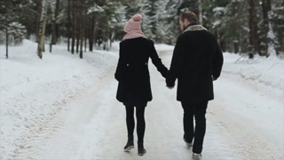 Winter Forest Stroll: Young Couple Enjoying Nature