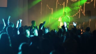 Belarus, Bobruisk, 20. 10. 2016 A rap rock concert. Black male rapper. Cheering crowd. White crowd. Professional smoke. Flashing lights.