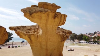 A steady shot of Yellow space rock in the desert. Big yellow futuristic mountains.