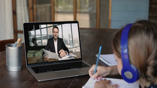 Online primary school teacher man giving online class to schoolkid