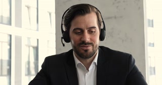 Young person in headphones speaking via video call