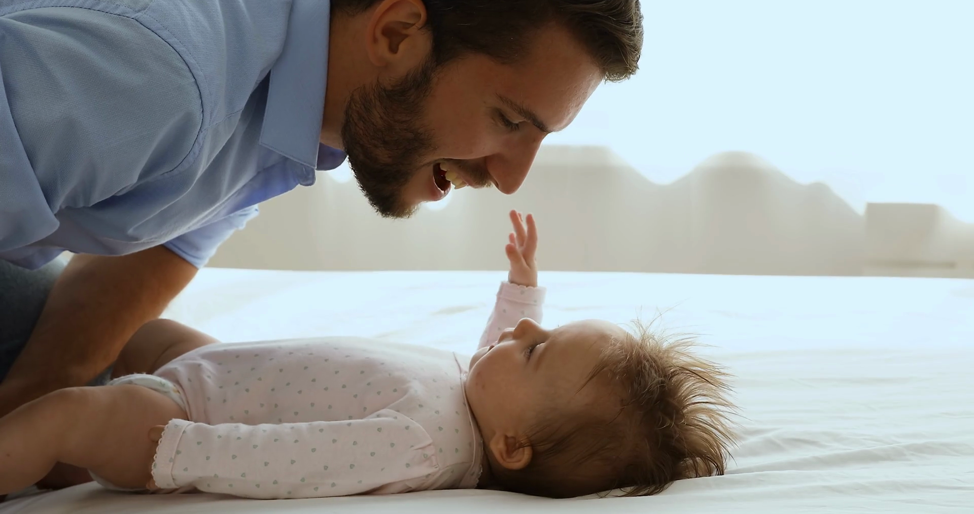 Happy loving new father bending over little baby Stock Video Footage 00