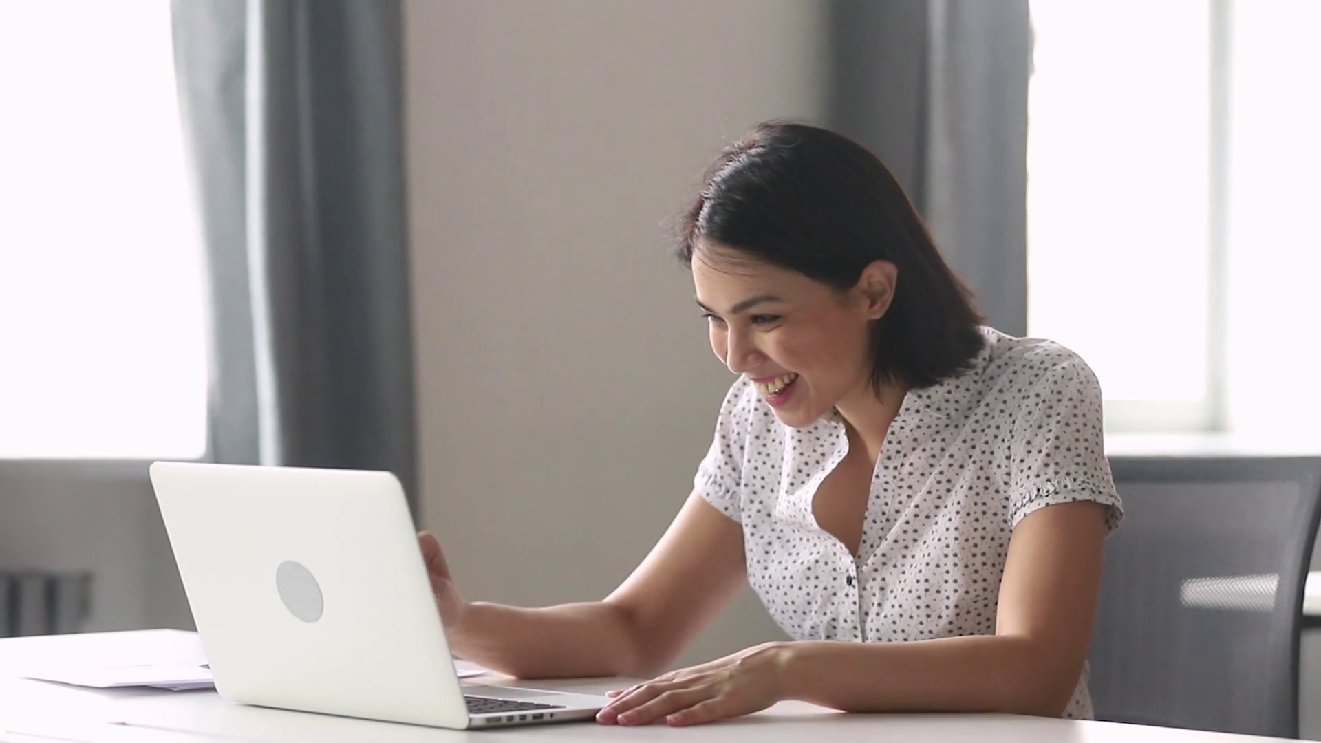 Asian woman employee having informal conversation video call in