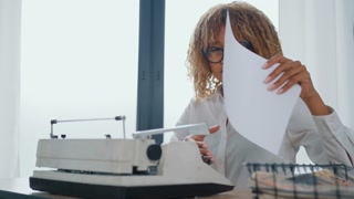 portrait writer at woman dressed white formal shirt sitting at the workplace with big windows