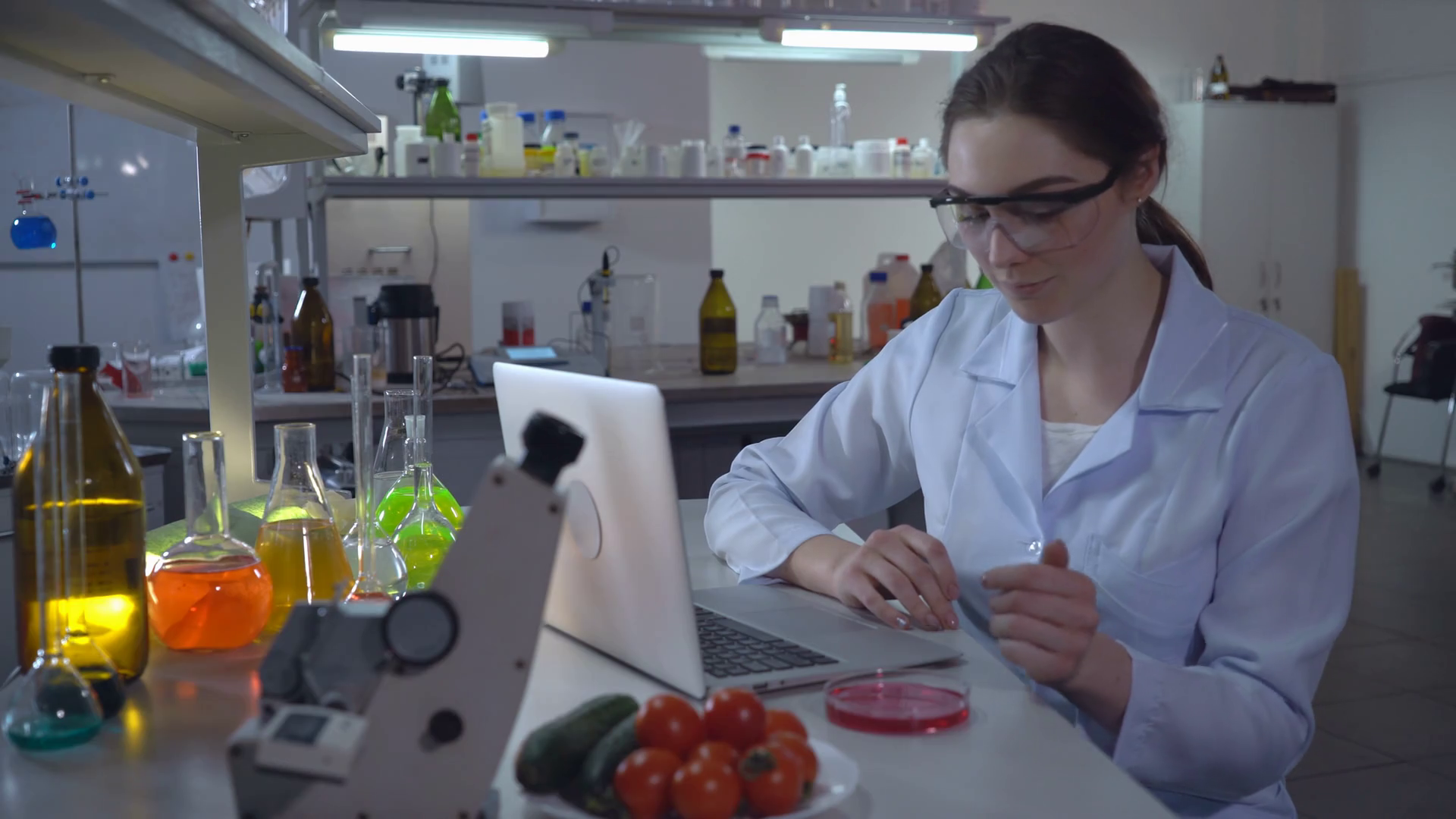 Lab technician conducts food quality test at working place. Woman