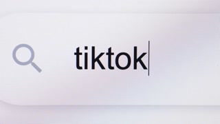 Social networking service. Searching For tiktok in Search Bar Screen View. Searching The World Wide Web Internet on a Computer. Typing Into Search Engine Box.