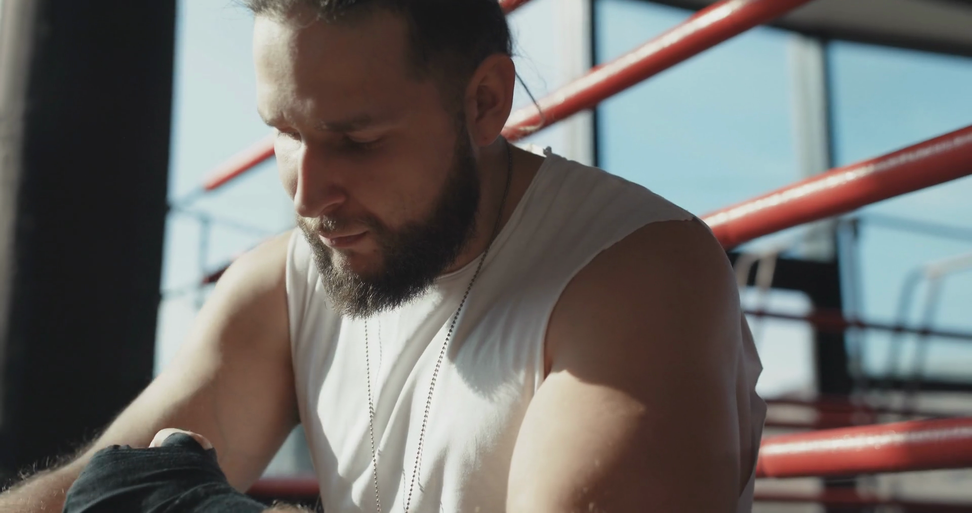 Boxer wraps his hands with black handwrap before the fight training