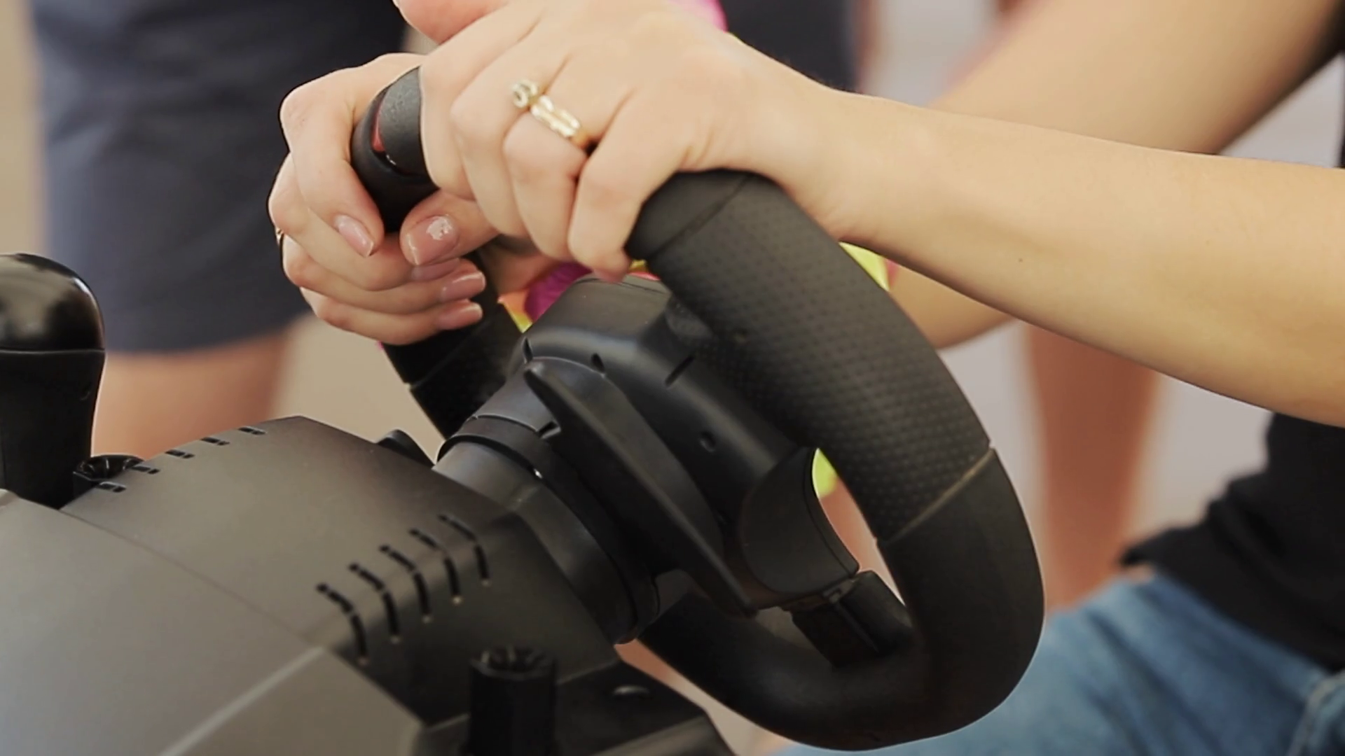 Close up Female hands plays auto simulatorr with Steering Wheel and Playing in Car Racing Online