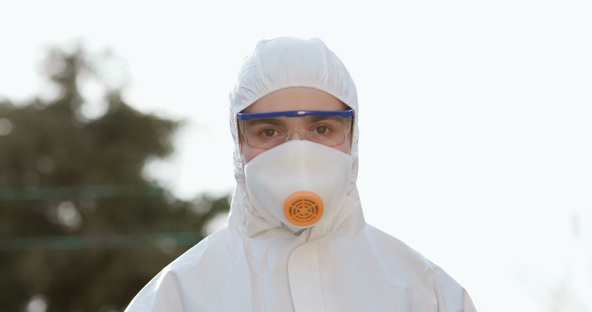 Close up of virologist worker in protective suit, goggles and