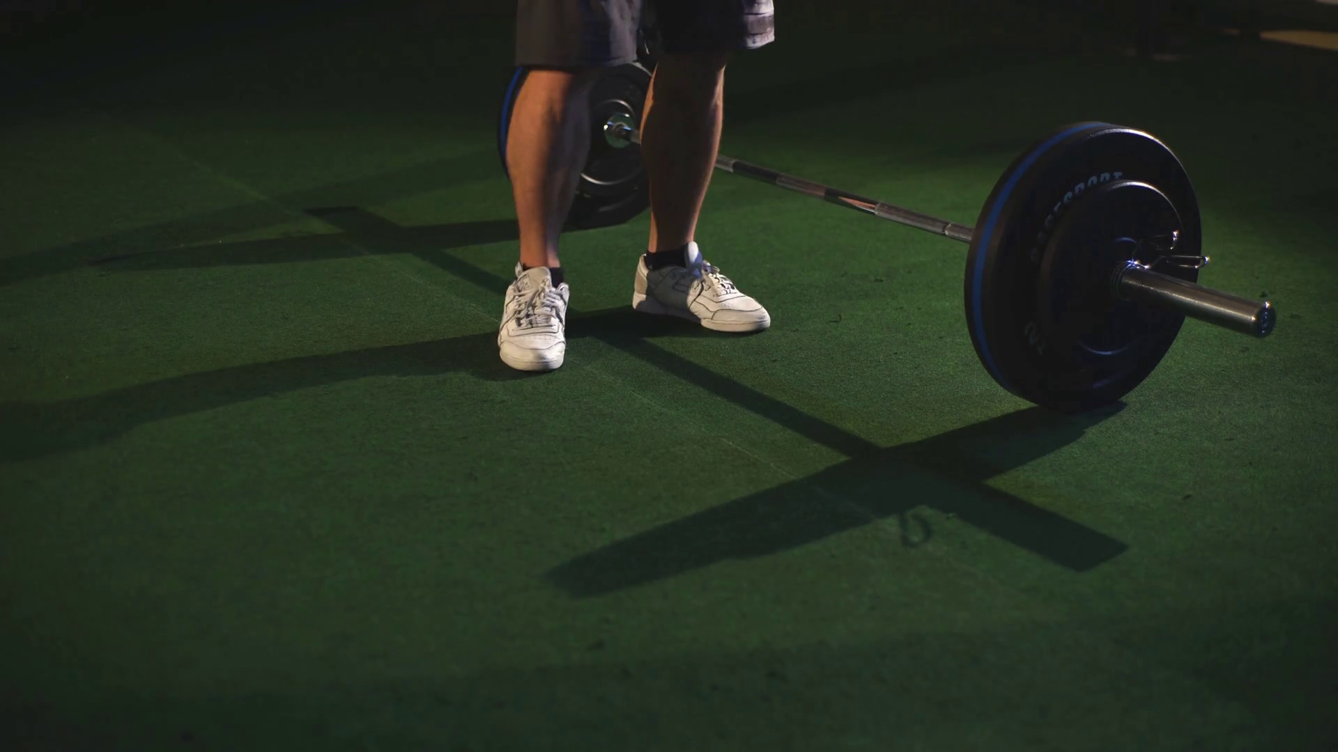 Men jumping over barbells during burpees exercise Stock Video Footage