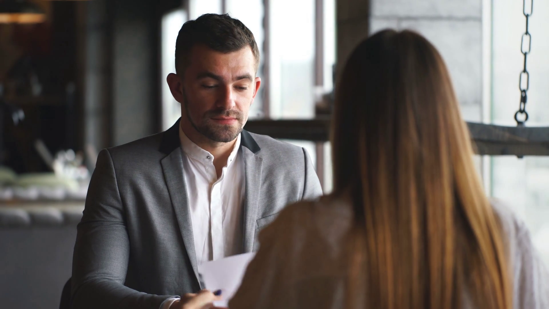 Young woman having a job interview with a corporate manager in his