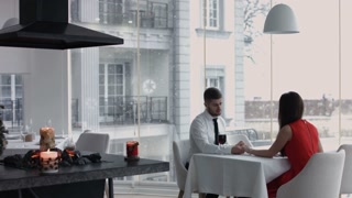 Joyful couple celebrating with wine at restaurant