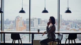 Serious boss talking mobile phone at cityscape office wearing suit zoom on. Stressed businesswoman having smartphone conversation indoors