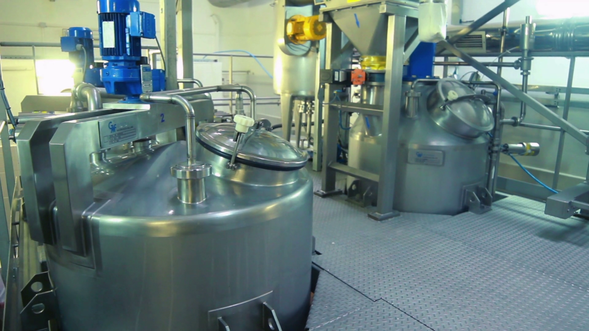 Interior of modern dairy factory. Milk tanks. Food processing equipment at factory. Food