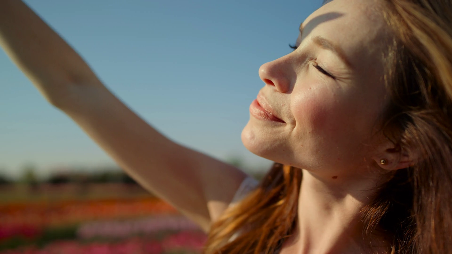 Portrait of beautiful woman looking at sun. Closeup young woman closing