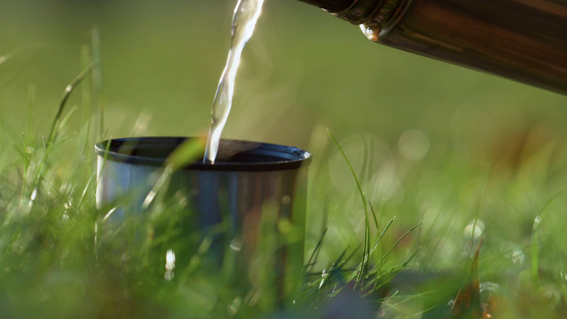 Pouring Hot Drink In Metal Cup On Green Stock Footage SBV346810523