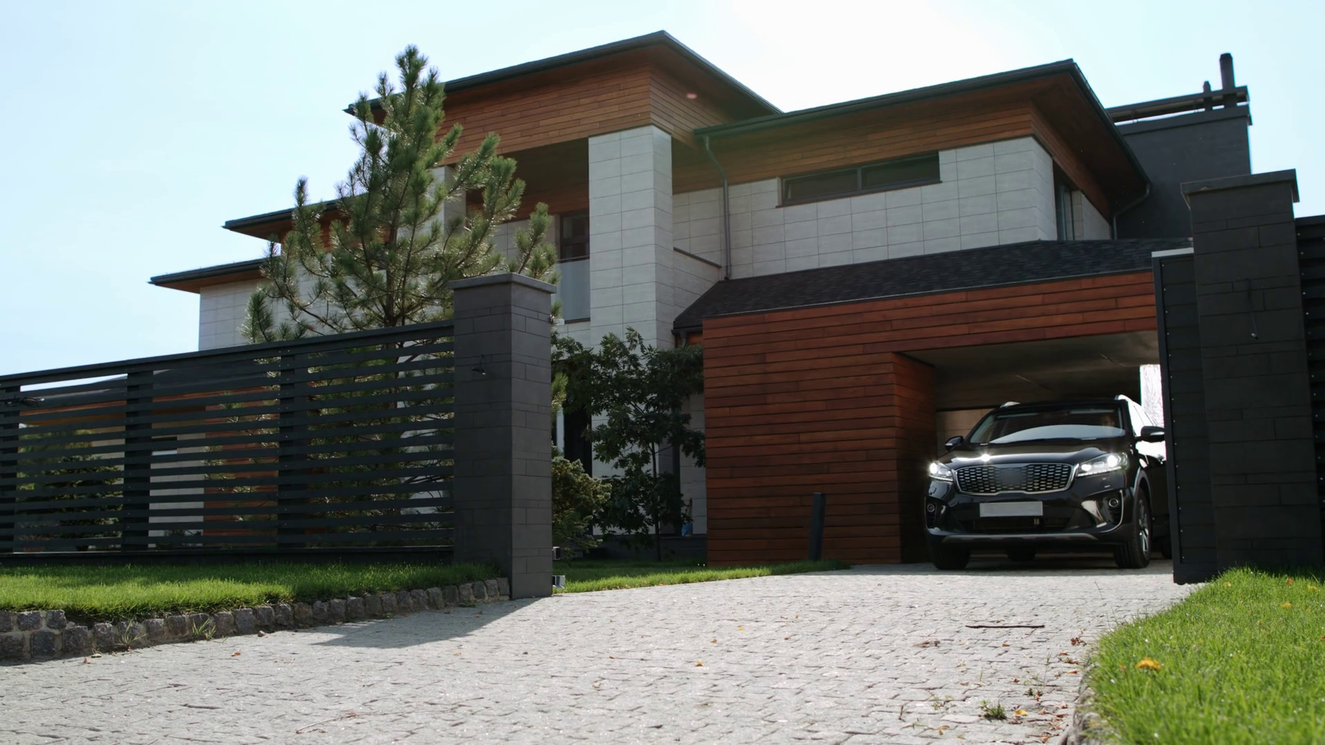 Black car riding from luxury house. Closeup of black jeep