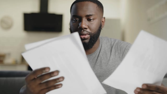 Confused After Looking At A Paper Stock Footage: Royalty-Free Video ...