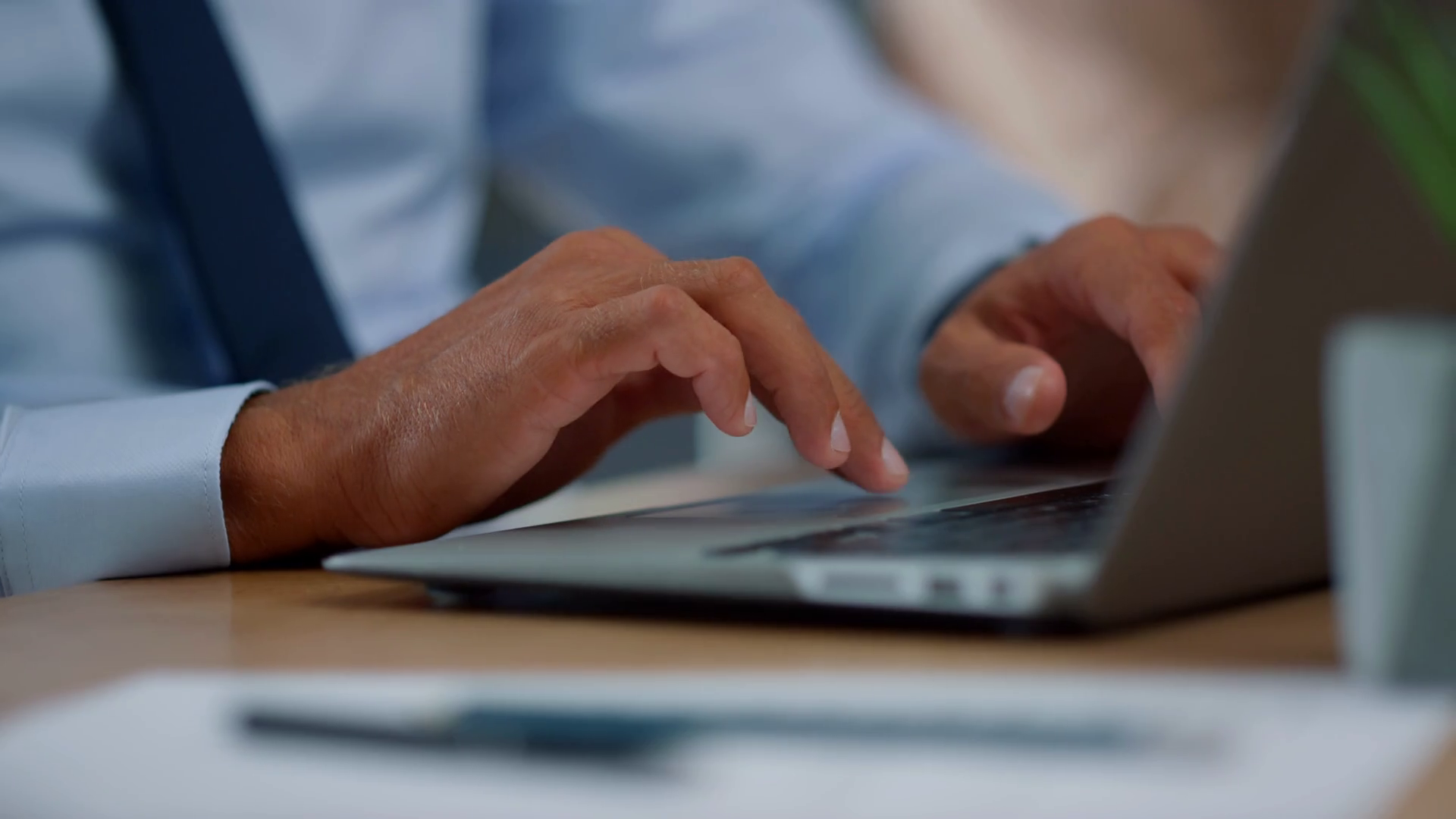Businessman hands using touchpad on laptop computer. Closeup male