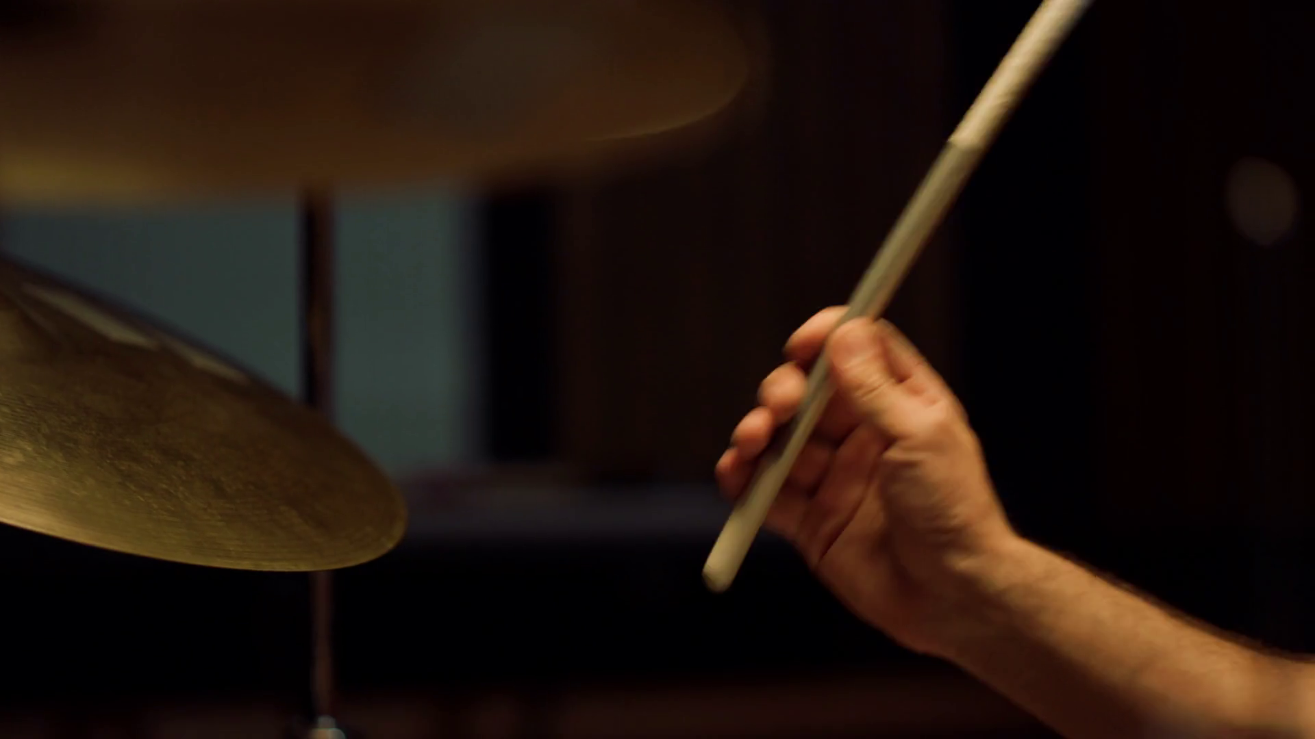 Closeup man hands hitting drum cymbals in concert hall. Unrecognizable