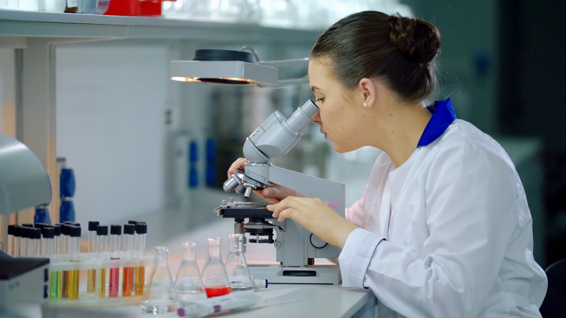 Female scientist with microscope in lab