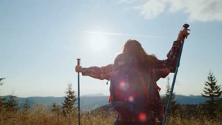Excited hiker celebrates victory on mountain