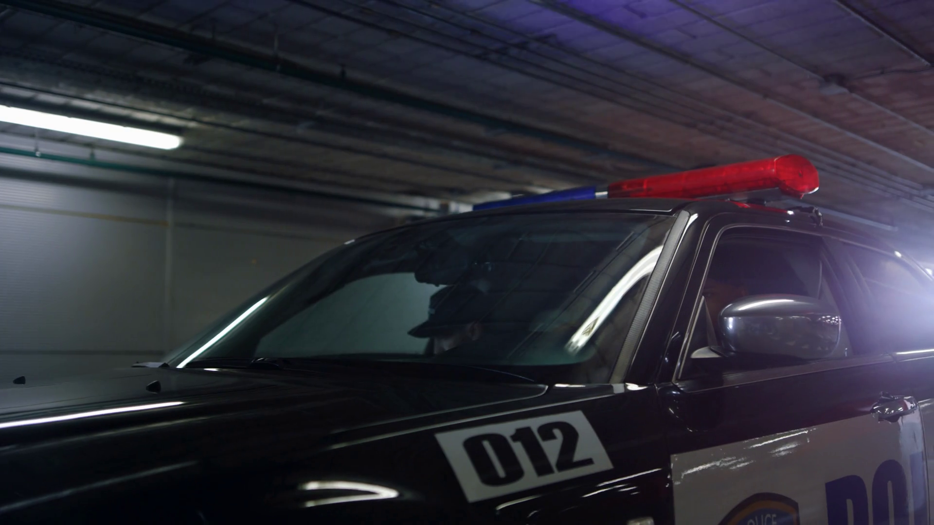 Male Cops Hiding Behind Doors Of Patrol Car Stock Footage SBV346484923