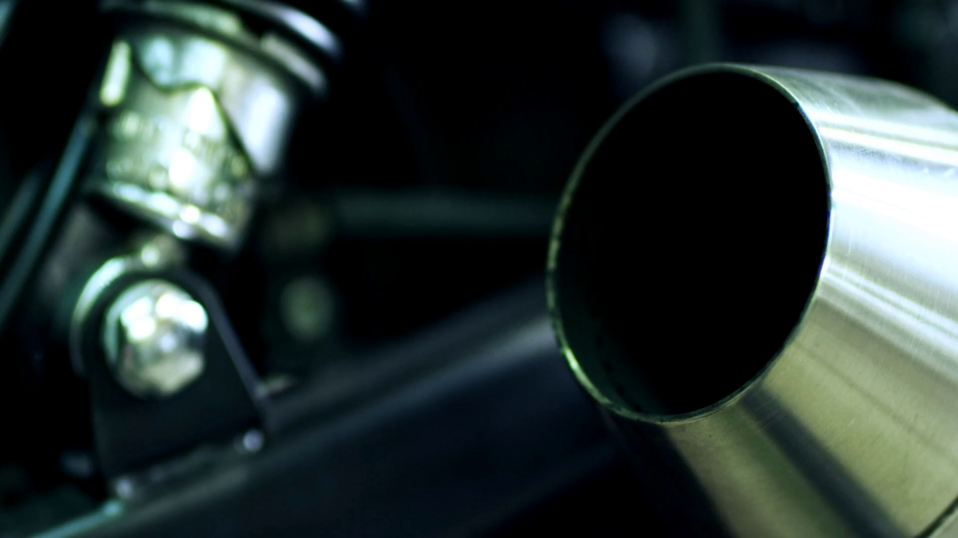 New chrome exhaust pipe with smoke. Closeup of combustion fumes coming