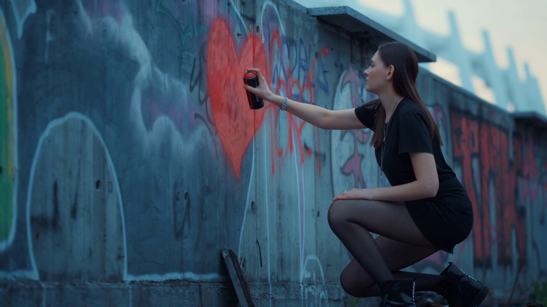 Stylish Girl Painting Heart On Wall With Spray Bottle Young Woman Drawing Graffiti On Abandoned Building Female Artist Using Aerosol Paint Bottle For Graffiti Hipster Painting Red Heart On Street Stock Video