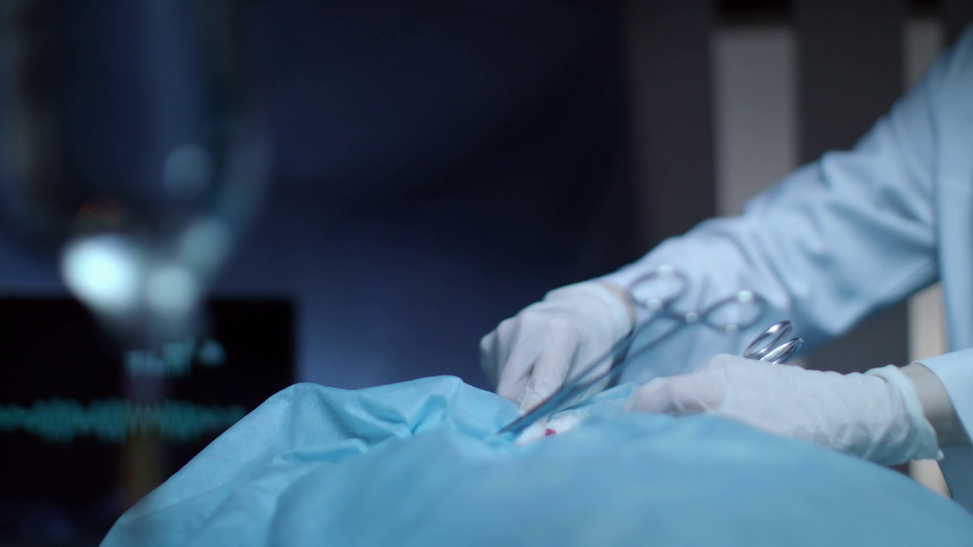 Surgical operation. Close up of surgery hand holding medical clamp