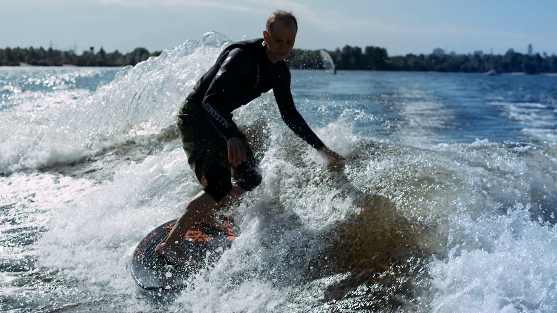 Wake surfing rider enjoy waves. Sportsman surfing on waves in slow