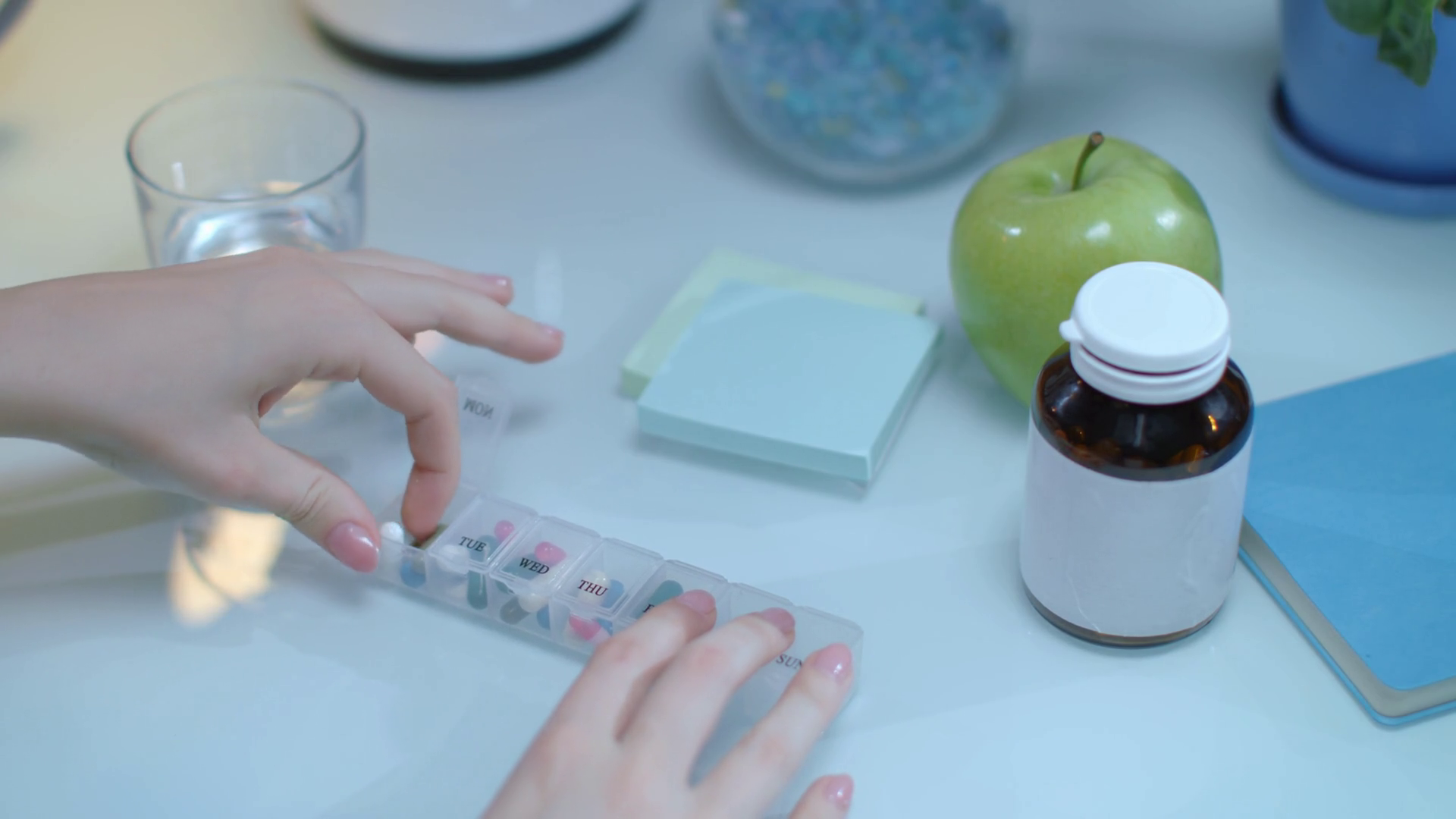 Woman take daily capsule from pill dispenser. Daily dose of taking
