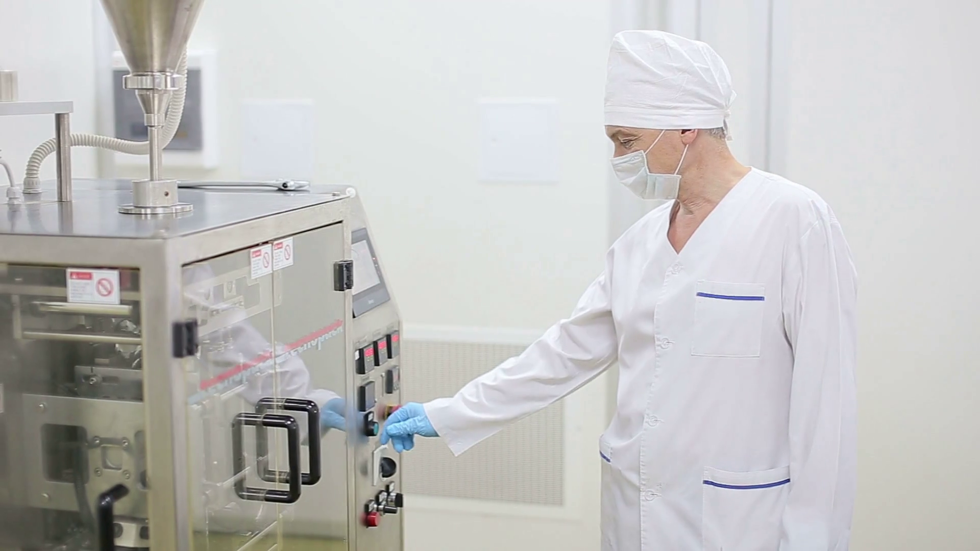 Technician starts factory packaging machine Stock Video Footage 0010