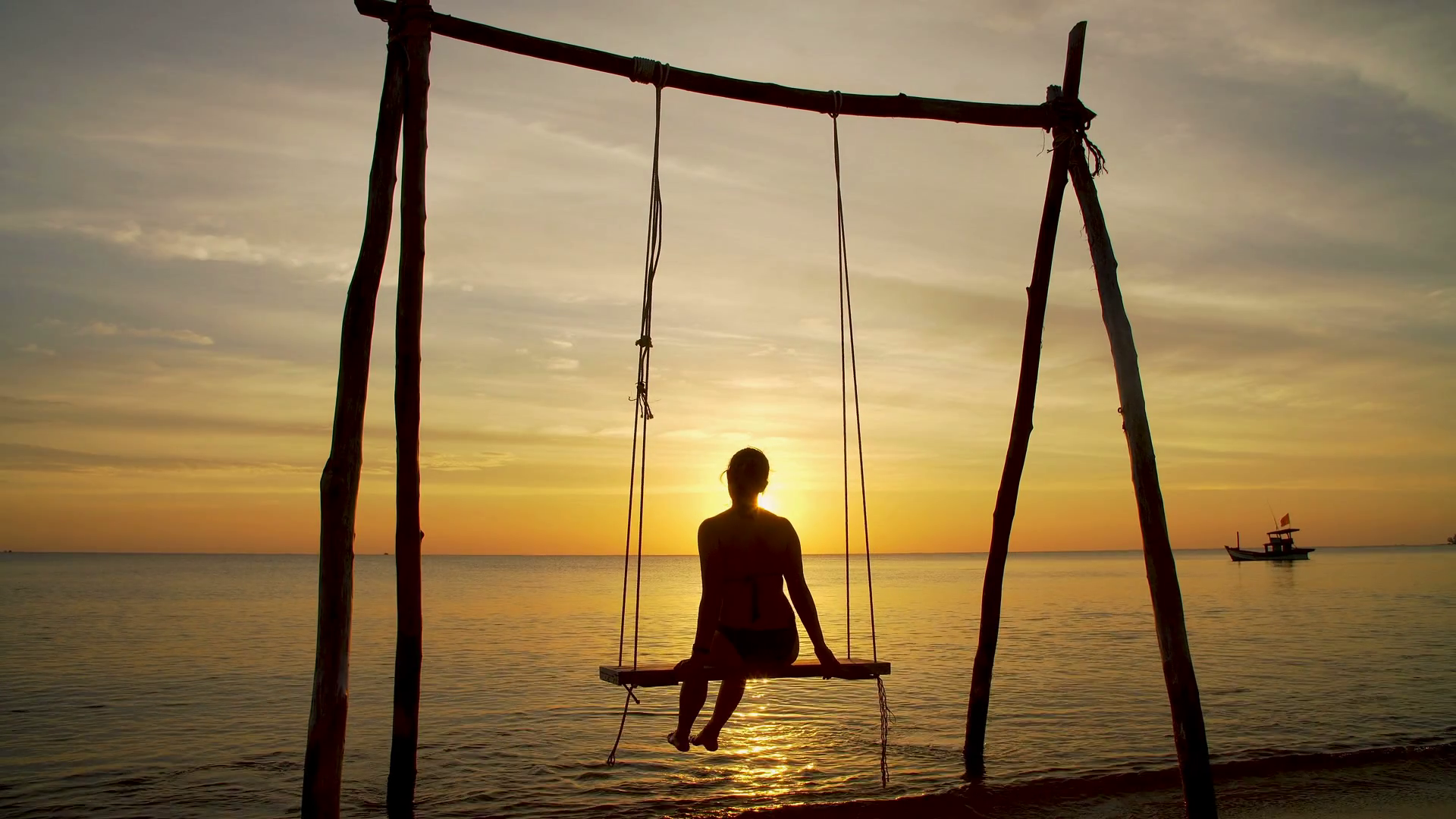 Girl on a swing by the seashore on sunset Stock Video Footage 0014 SBV