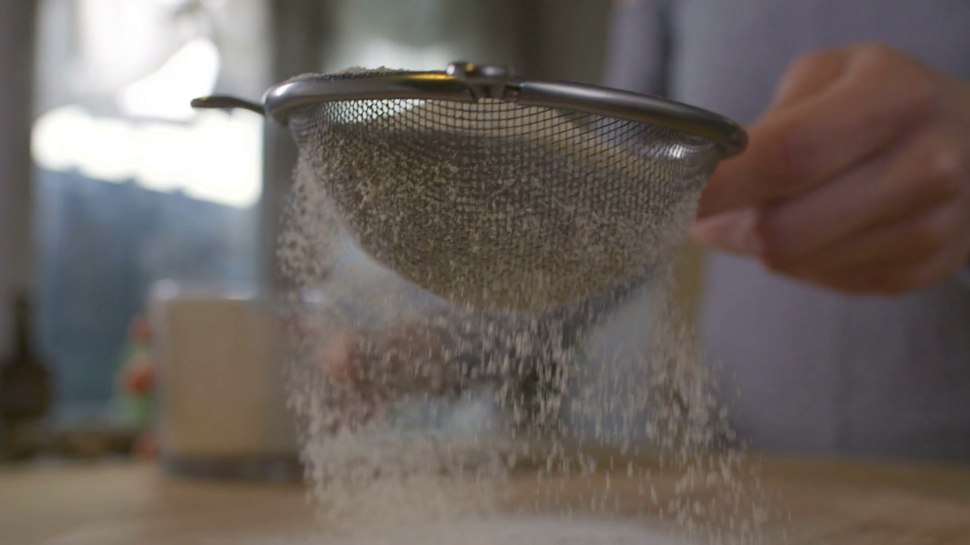 Woman sifting flour through a sieve Stock Video Footage 0033 SBV
