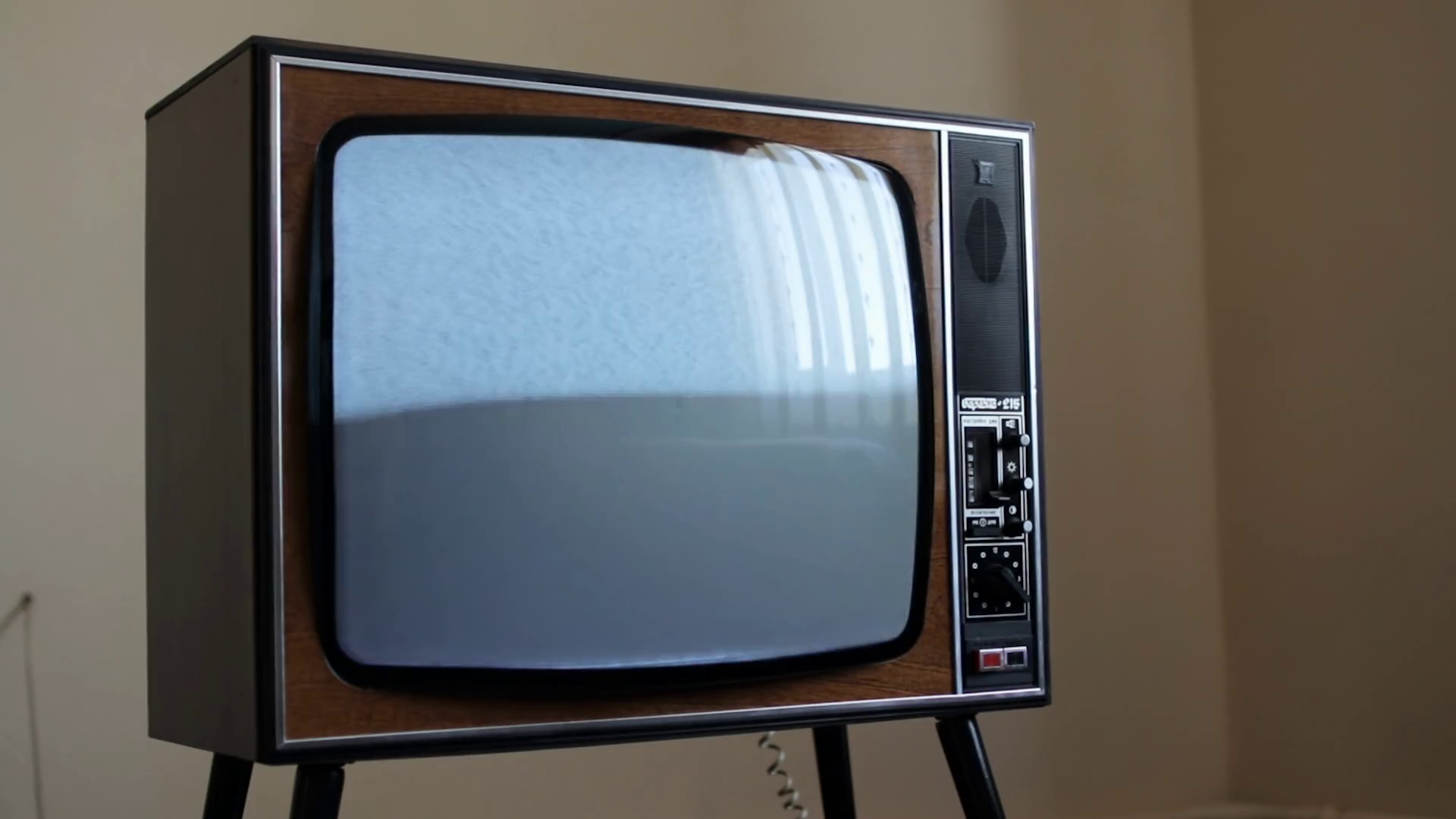 Vintage television with blinking screen, antique TV with static noise