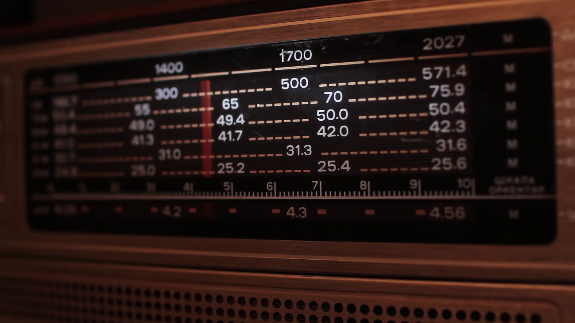 Close up of a vintage radio dial with the stations and frequencies being tuned Stock Video
