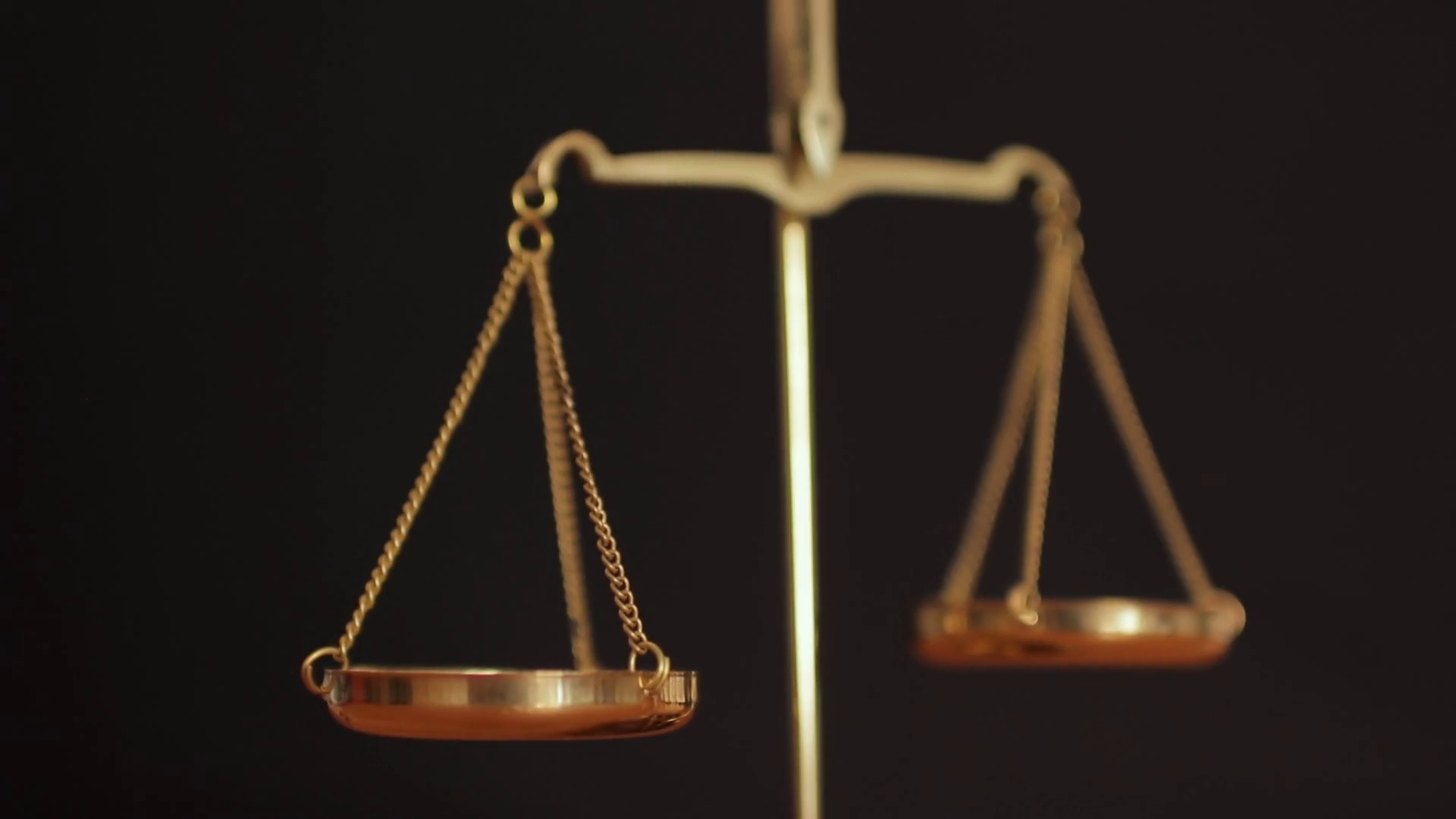 Golden justice scales close up on black background Stock Video Footage