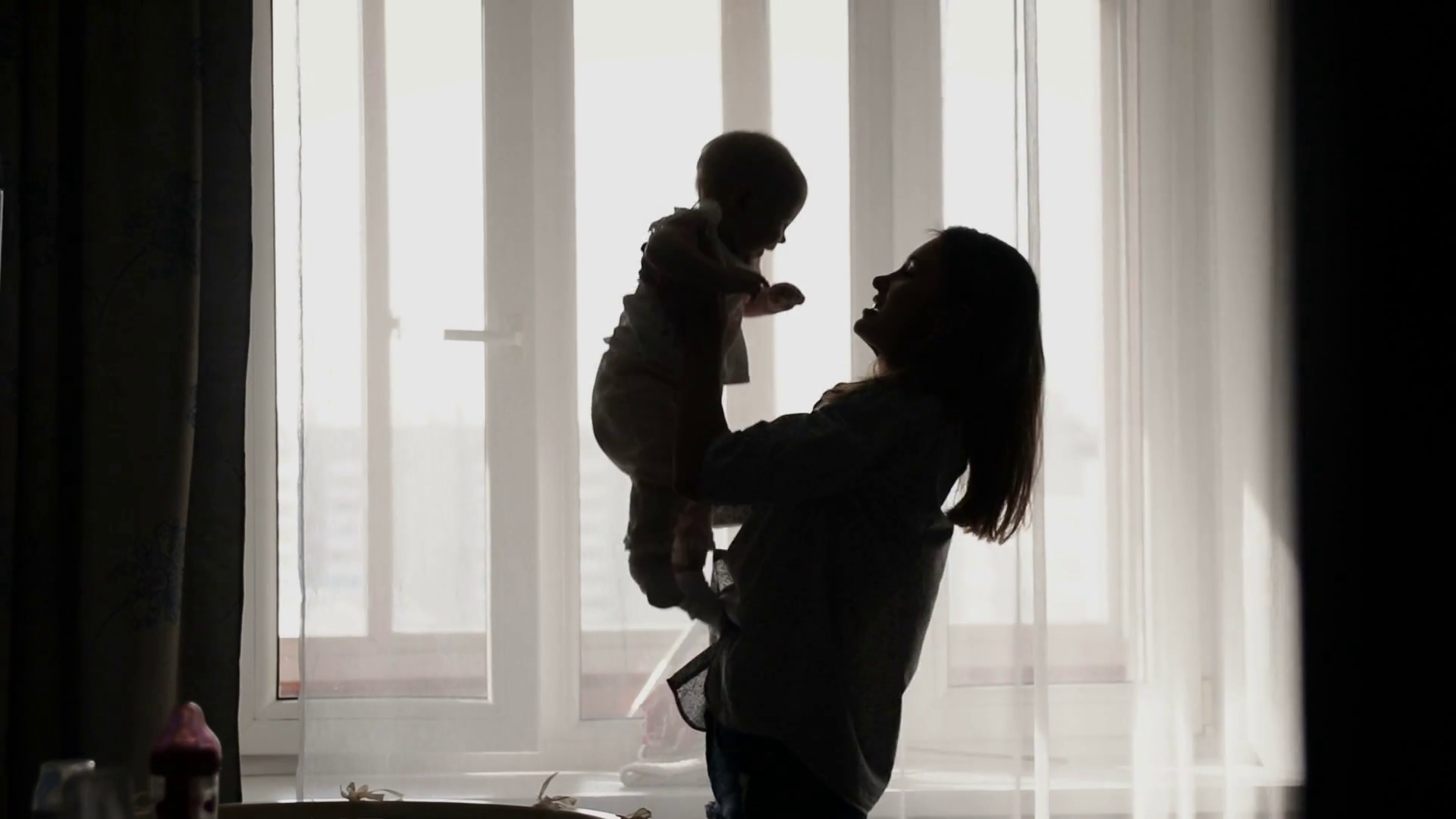 Silhouette Of Mother Throwing Baby Up Stock Footage SBV338591109