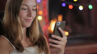 A joyful shopper completes her online purchase with a smartphone, amidst a festive backdrop.