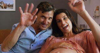 Expecting couple bids farewell on a video call