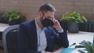 Middle-Eastern Man in Face Mask: Remote Office Meeting on Coronavirus