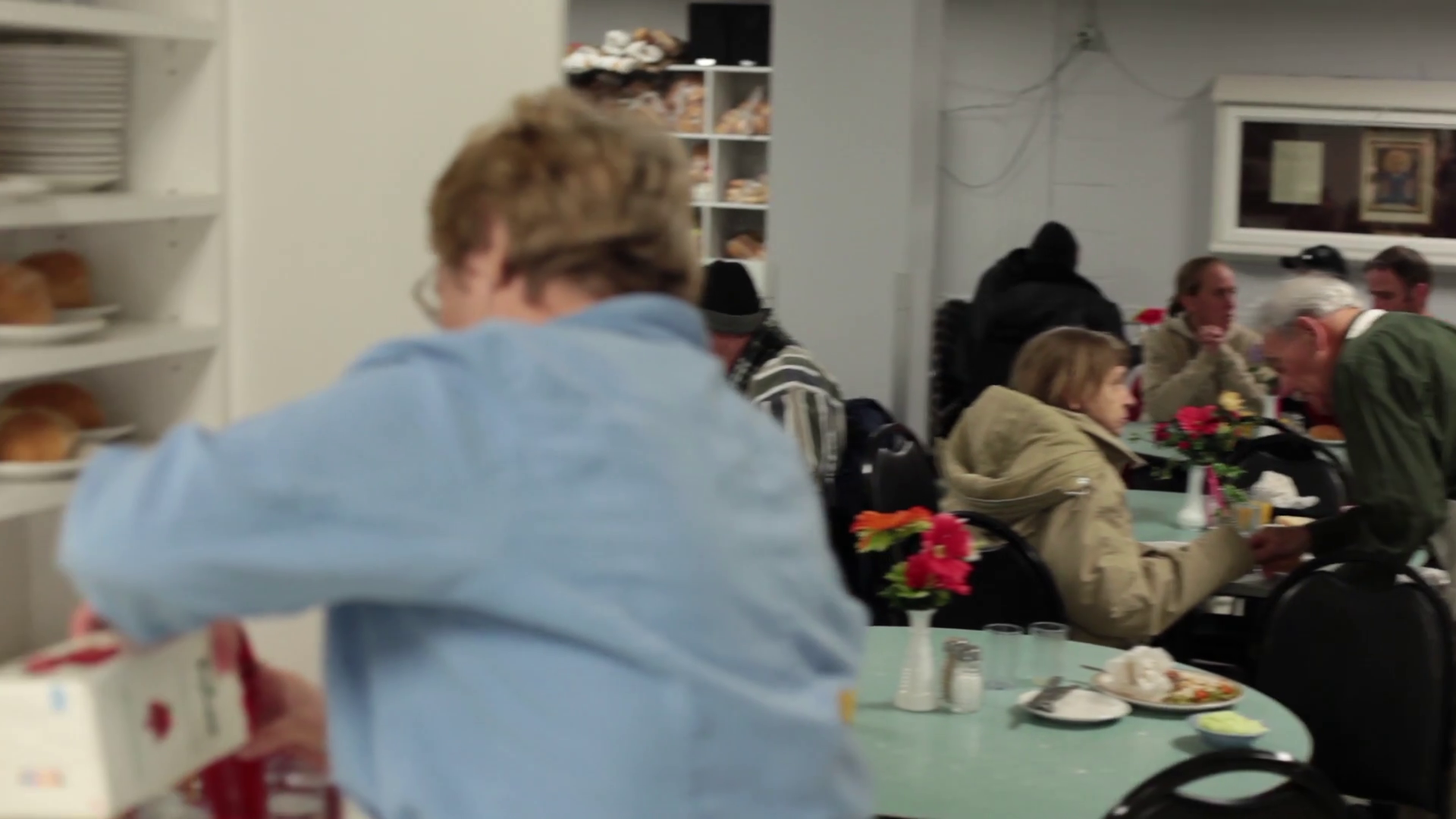 Volunteer in soup kitchen pouring juice Stock Video Footage 0007 SBV