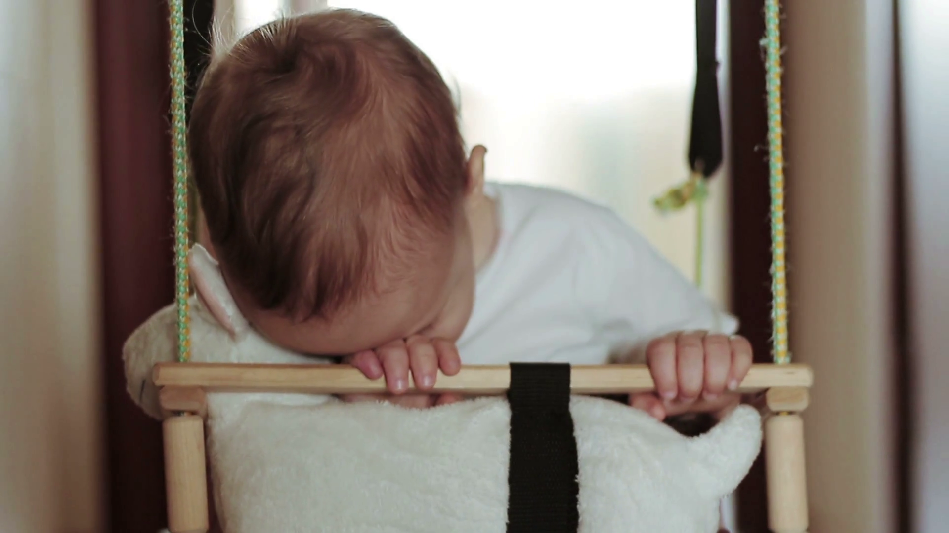 A Little Baby Boy Sleeping In Swing At Home Stock Footage SBV311891633