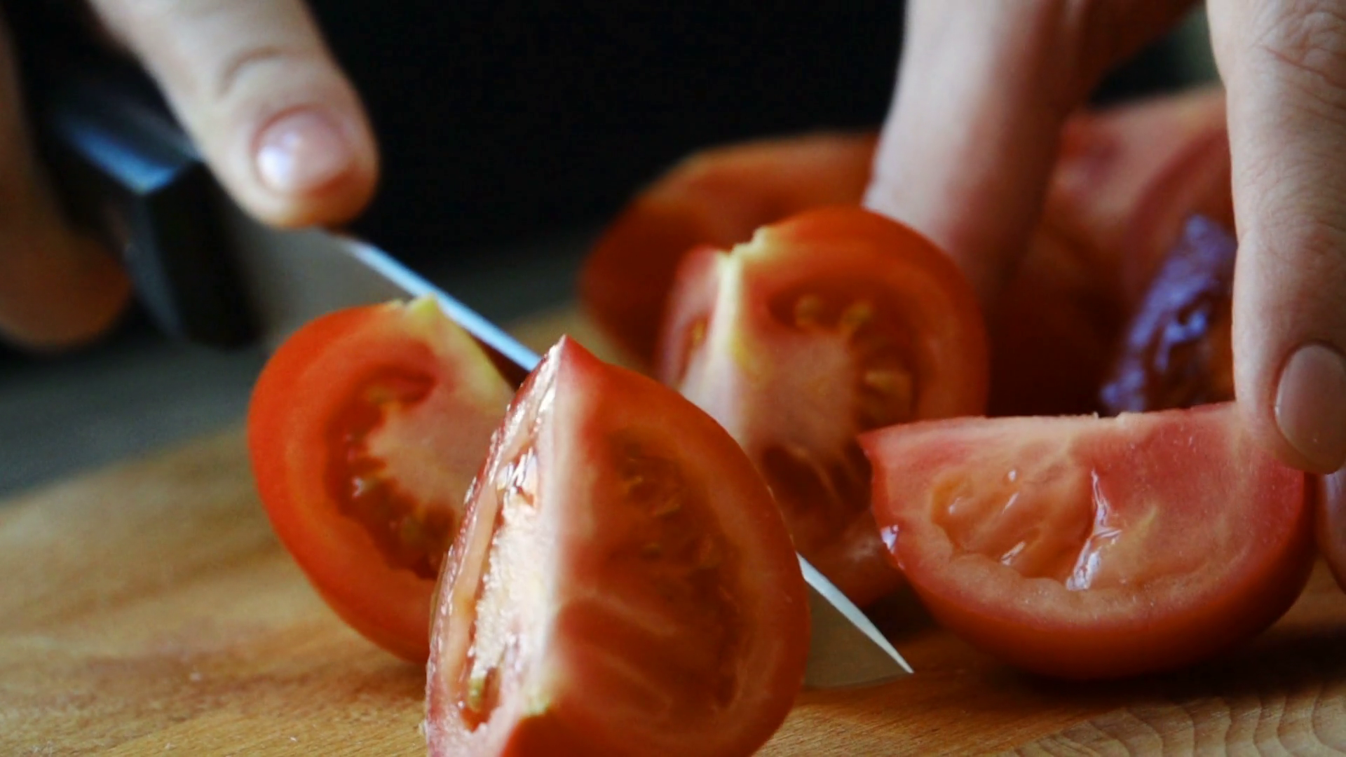 Cutting tomato by culinary knife. Slow motion Stock Video Footage