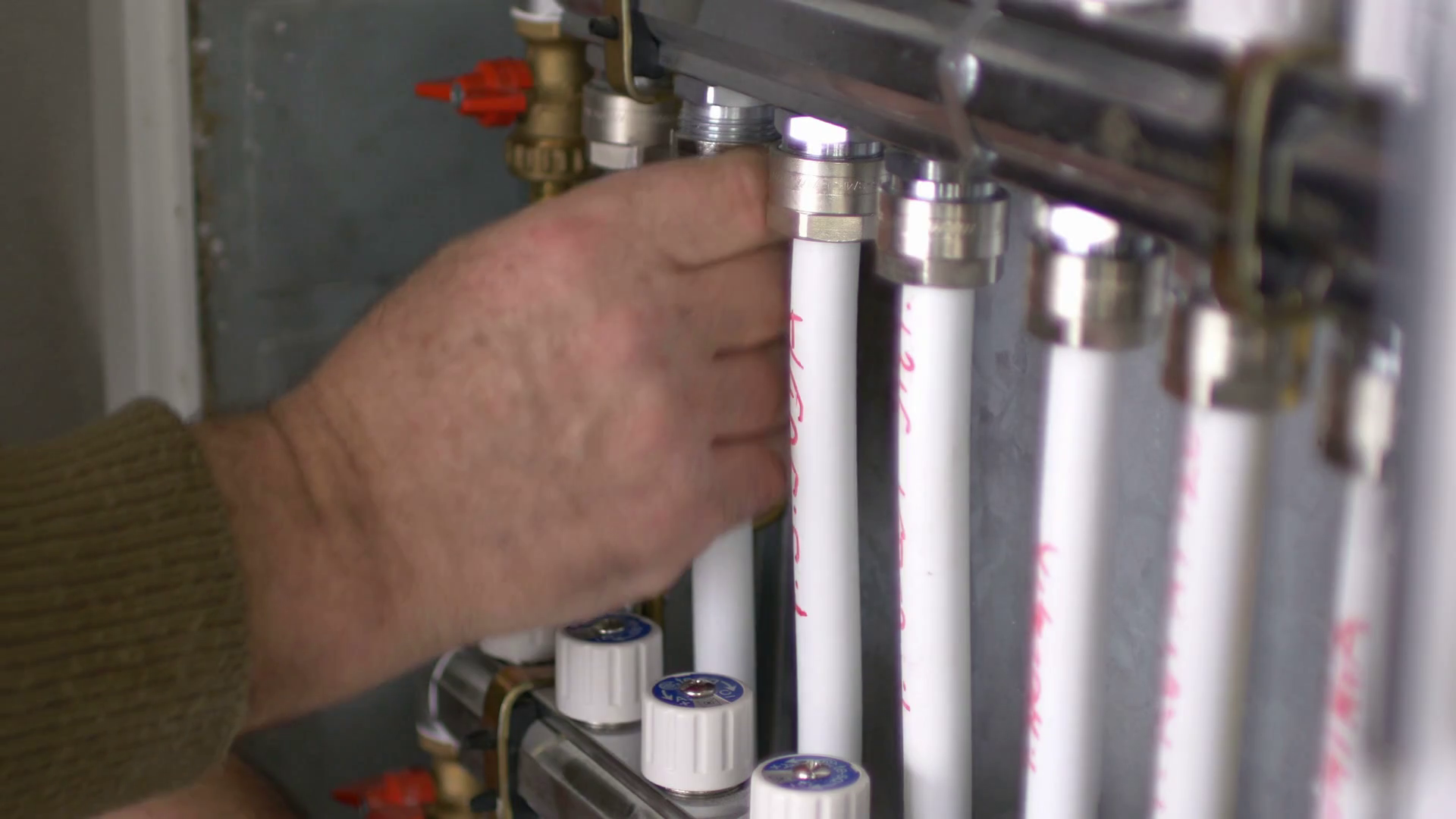 A man tightening the heating pipes of a central heating system... Stock